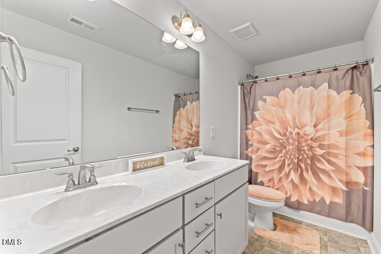 117 Boomer Street Benson, NC 27504 - Photo 28 of 31 a bathroom with a sink vanity granite and a mirror