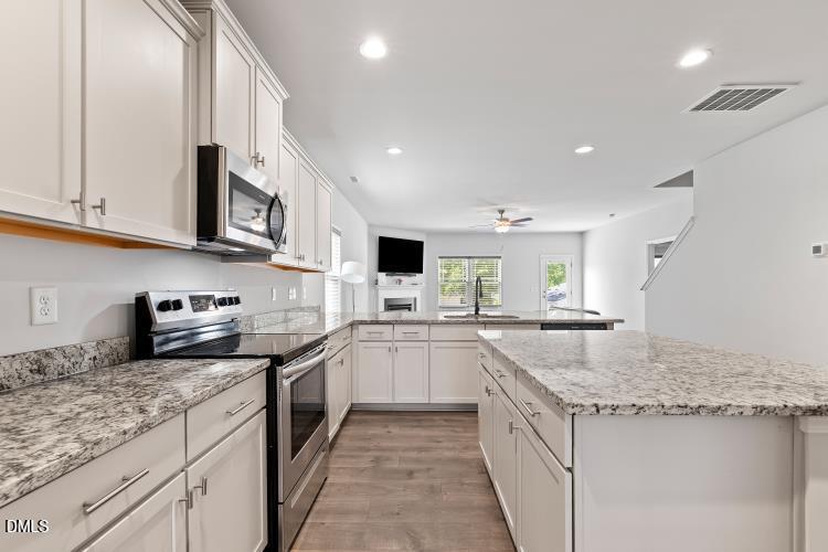 117 Boomer Street Benson, NC 27504 - Photo 9 of 31 a kitchen with granite countertop a sink and white cabinets