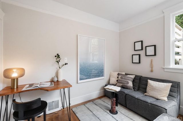 a living room with furniture a lamp and a window