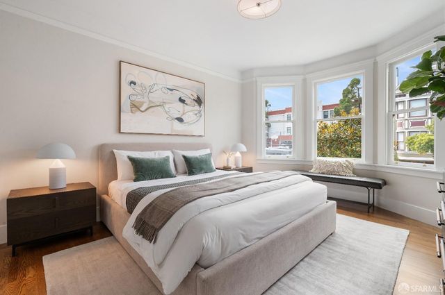 a bedroom with a large bed and a window