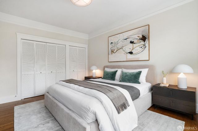 a bedroom with a bed and a painting on the wall