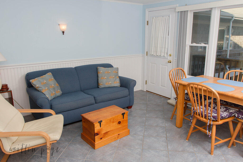 154 Old Wharf Road, Unit 19 Dennis Port, MA 02639 - Photo 5 of 15 a living room with furniture and a gym machine