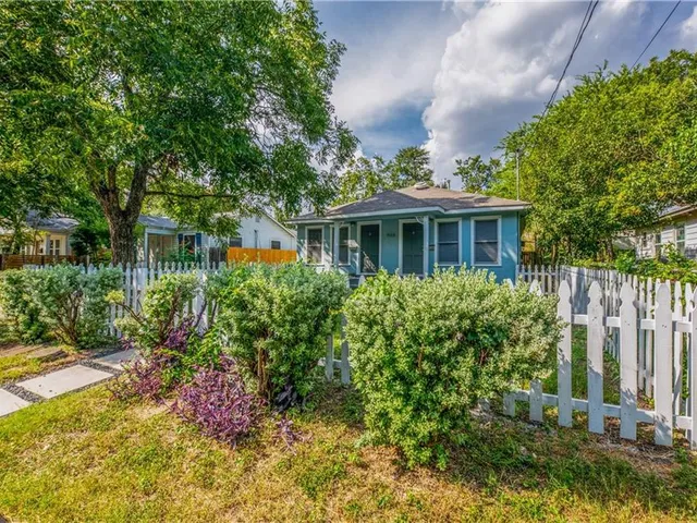 a view of a house with a yard and garden