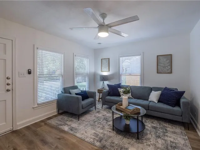 a living room with furniture and a large window