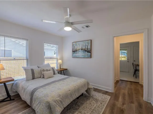a bedroom with a large bed and a chandelier
