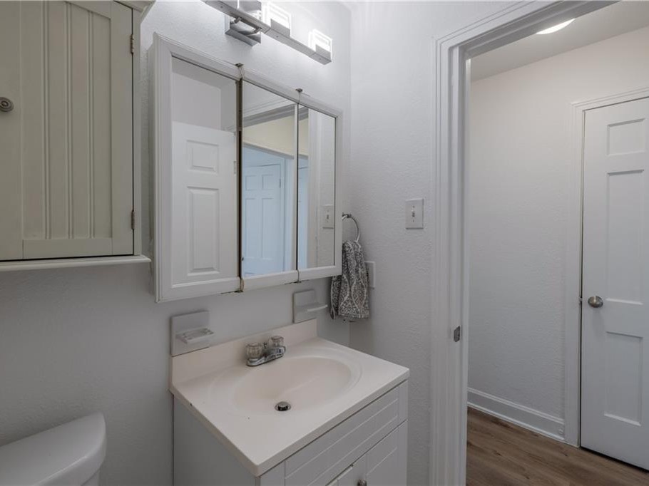 906 Capitol Court, Unit B Austin, TX 78751 - Photo 7 of 12 a bathroom with a sink a toilet and shower