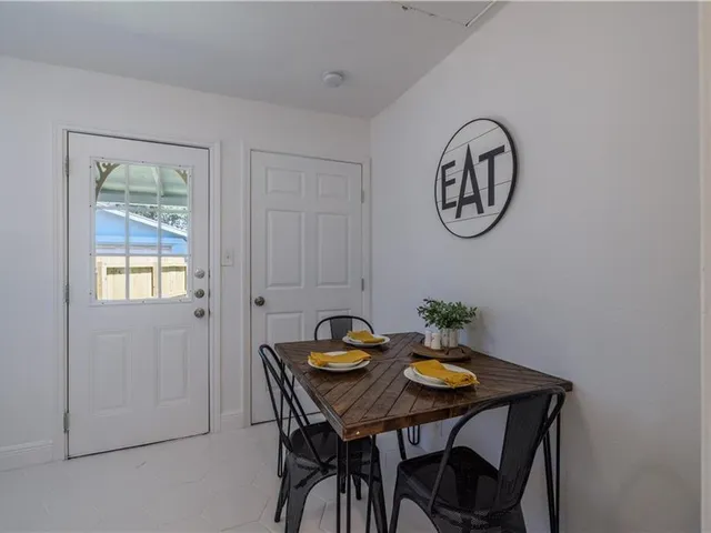 a view of a dining area with furniture and a window