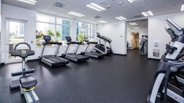 a room with gym equipment and a large window