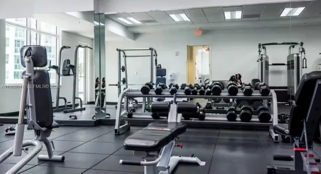 a room with gym equipment and mirrors