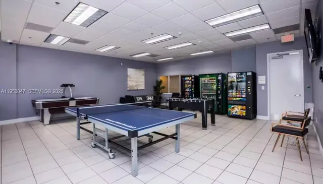 a room with furniture pool table and flat screen tv