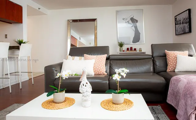 a living room with furniture and a dining table