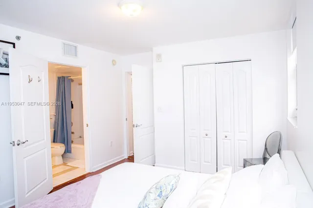 a bedroom with a bed and a mirror