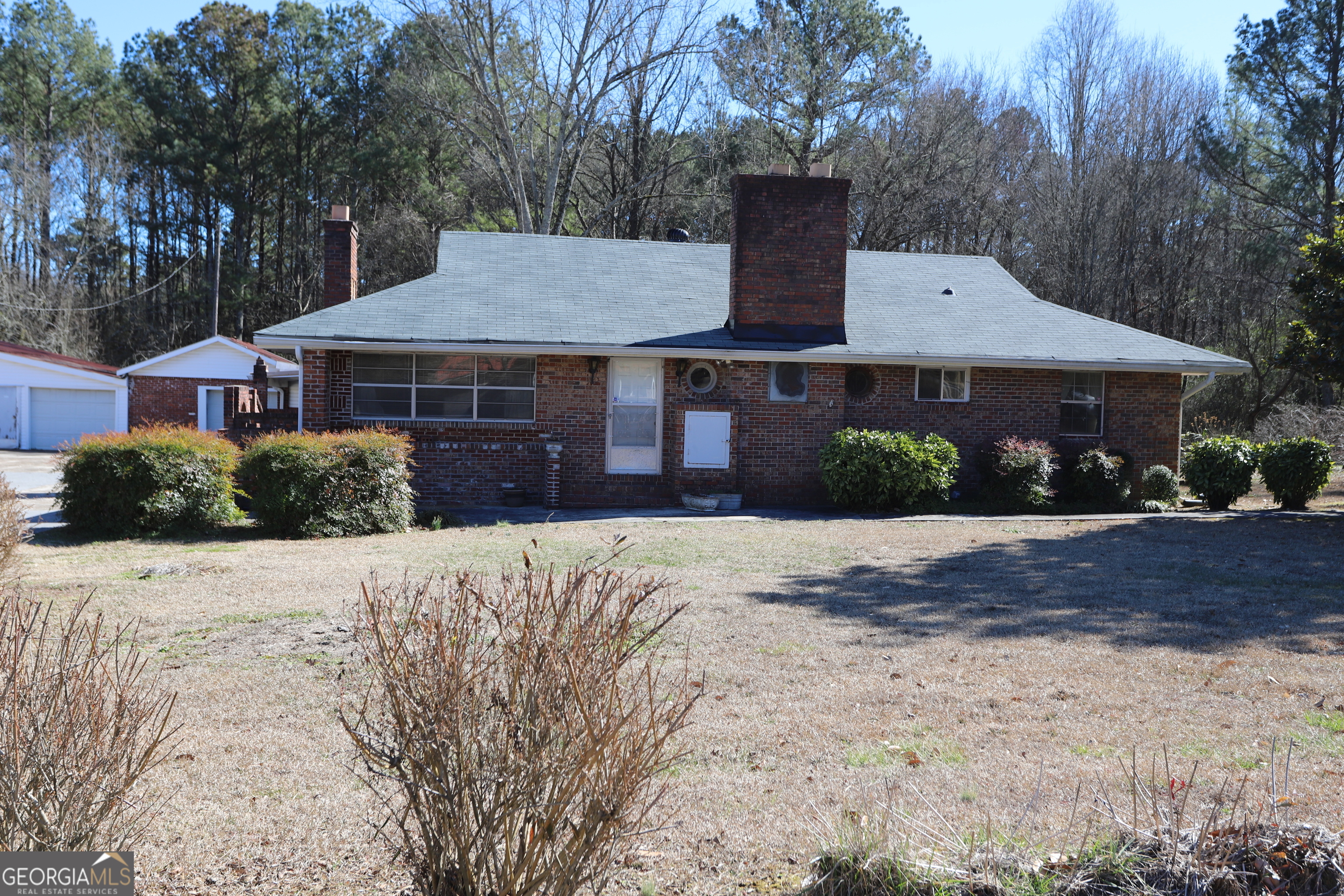 6797 Highway 114 Lyerly, GA 30730 - Photo 1 of 56 a front view of a house with a yard and garage