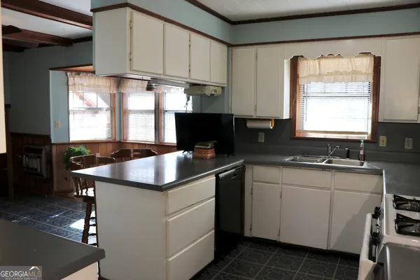 a kitchen with stainless steel appliances a refrigerator and a stove top oven