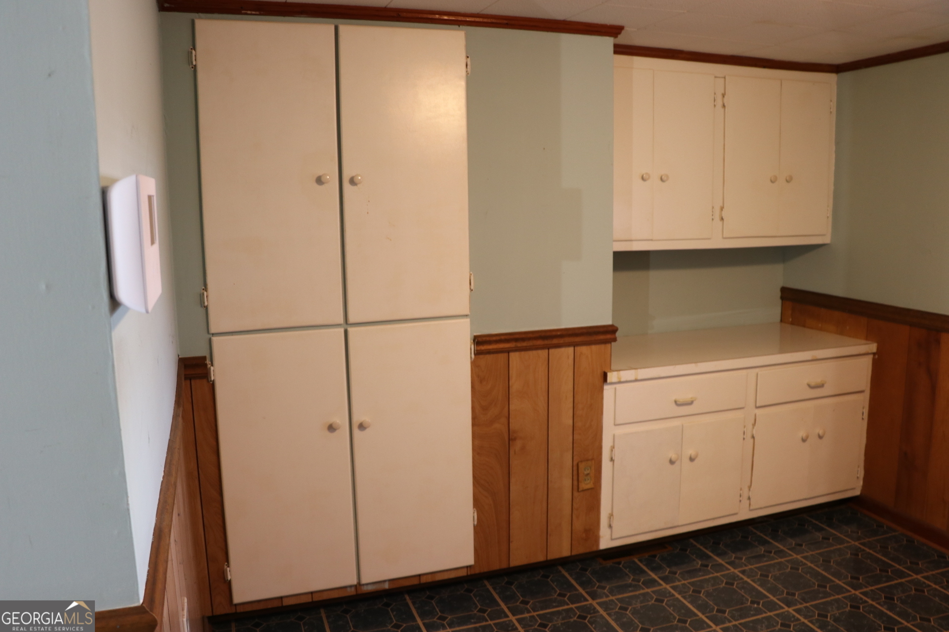 6797 Highway 114 Lyerly, GA 30730 - Photo 22 of 56 a kitchen with white cabinets and white appliances
