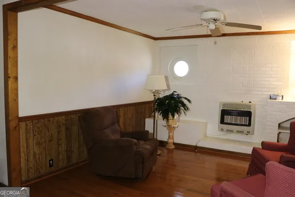a view of empty room with wooden floor and fireplace