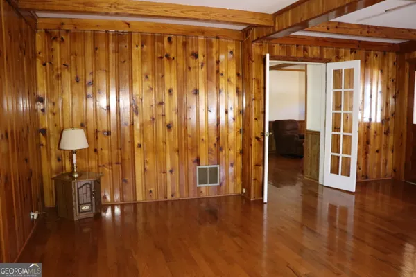 a view of a hallway with furniture and wooden floor