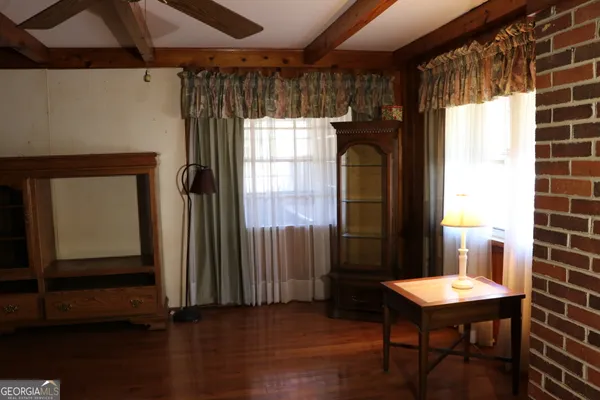 a room with kitchen island a stove a sink and a large window
