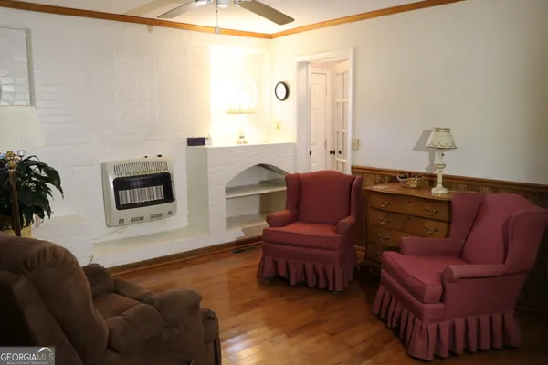 a bed sitting in a bedroom next to a window and a chandelier