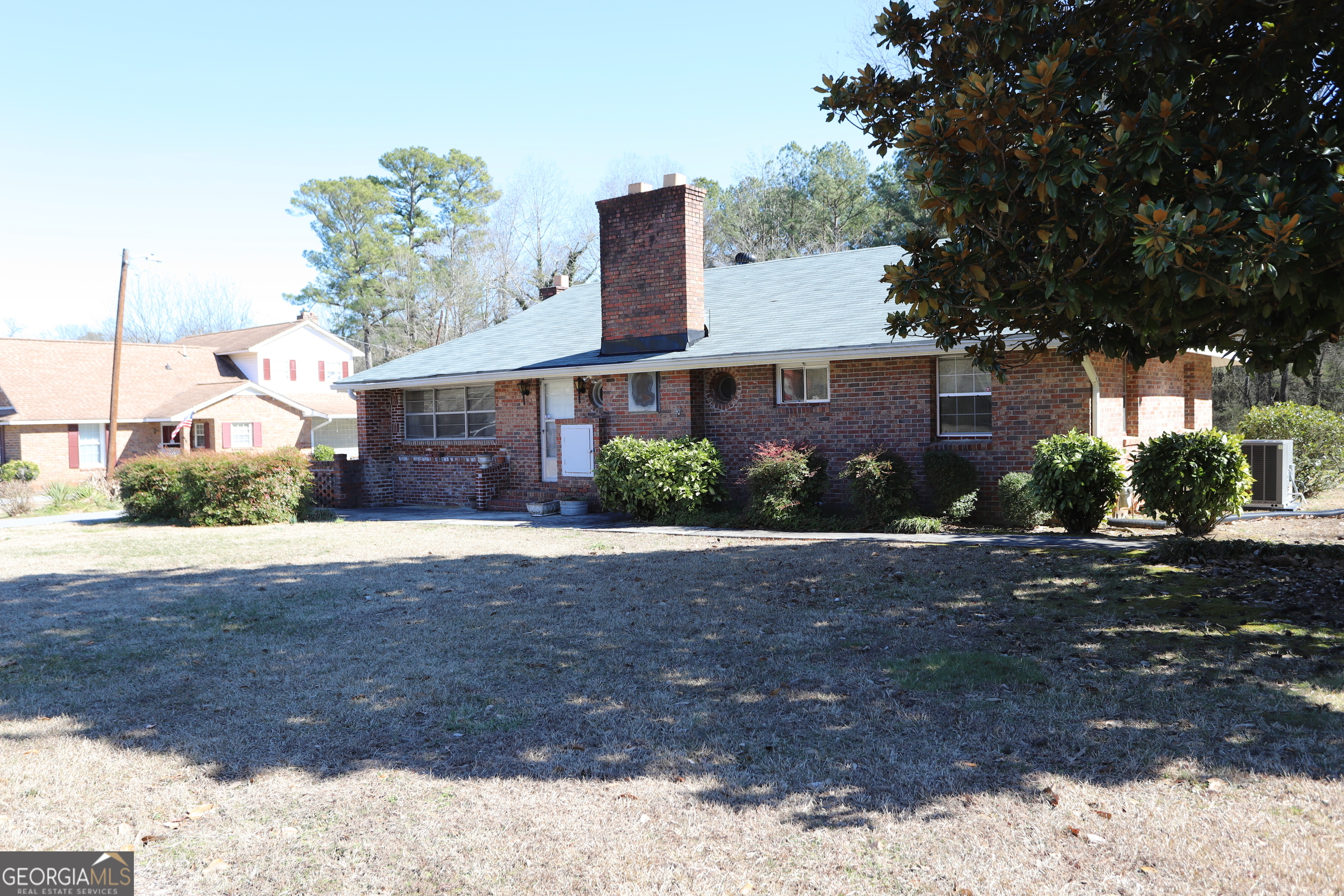 6797 Highway 114 Lyerly, GA 30730 - Photo 4 of 56 a front view of a house with a yard and garage