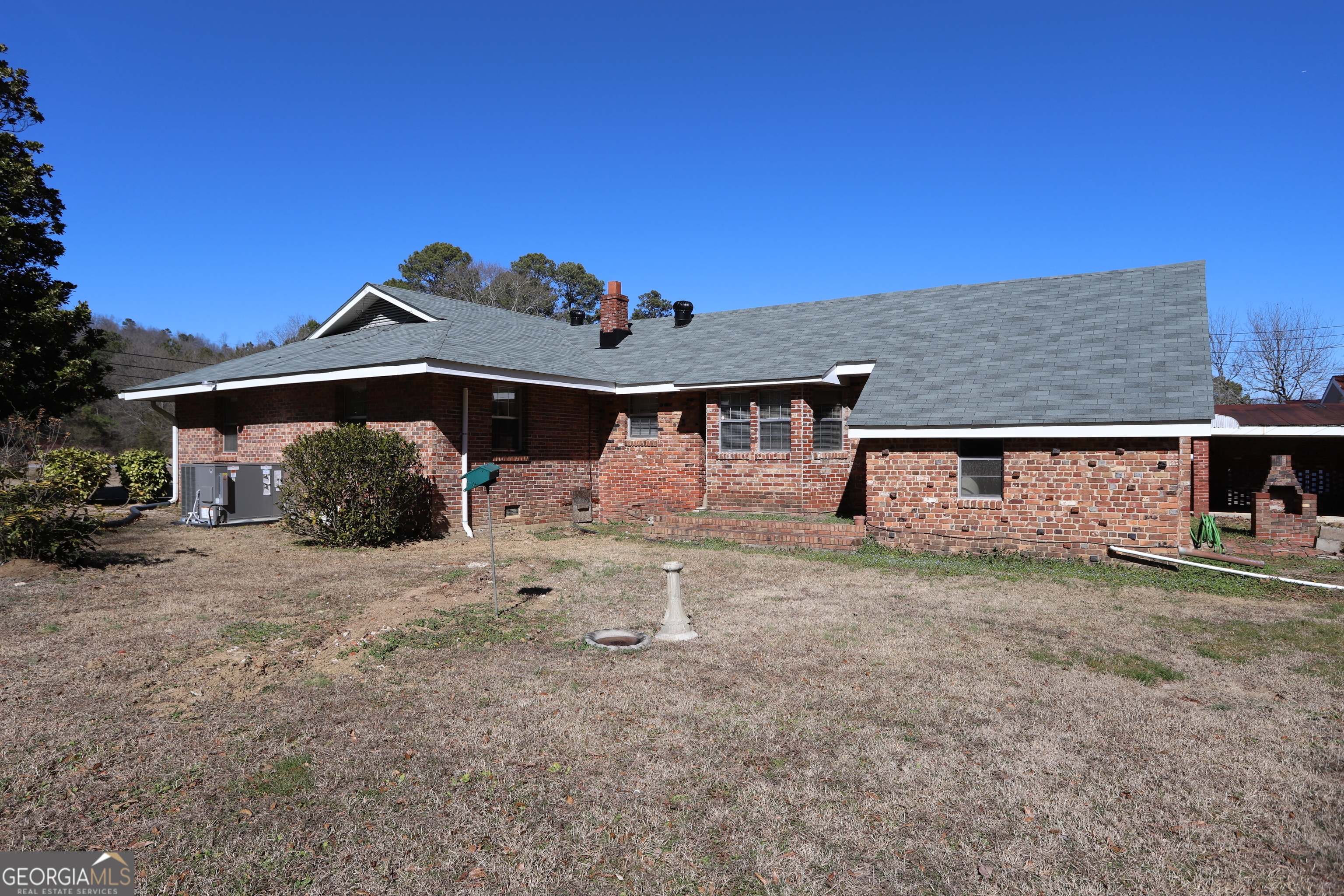 6797 Highway 114 Lyerly, GA 30730 - Photo 6 of 56 a front view of a house with garden