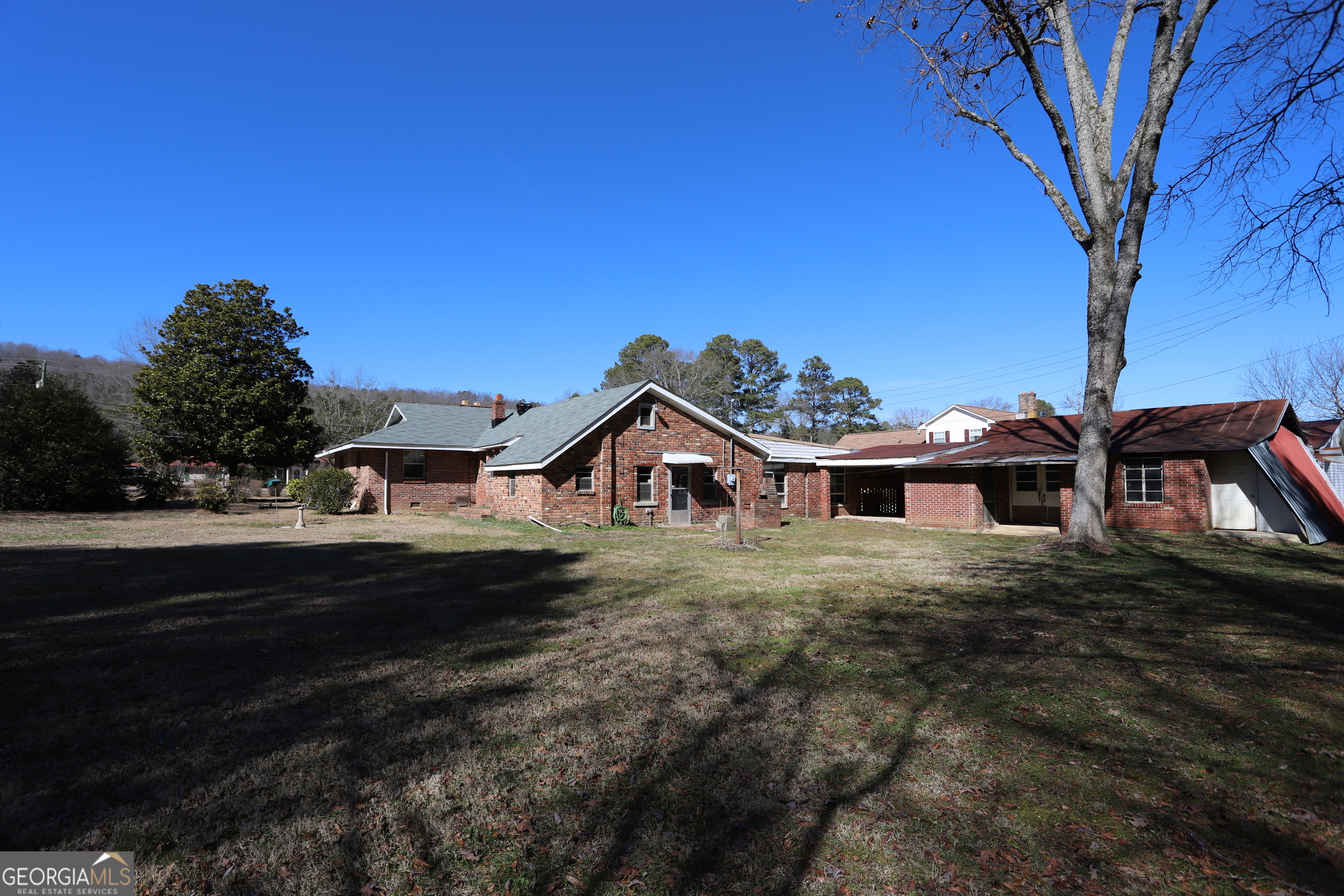 6797 Highway 114 Lyerly, GA 30730 - Photo 8 of 56 a front view of a house with a yard