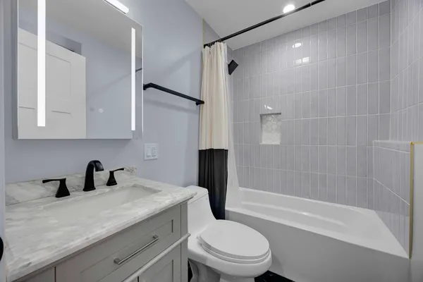 a bathroom with a sink a toilet and a bathtub