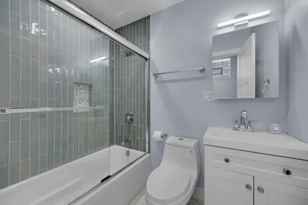 a bathroom with a sink toilet and shower