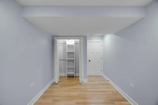 a view of an empty room and wooden floor