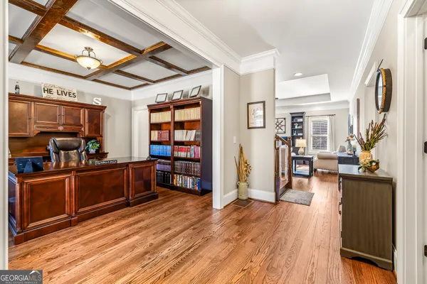 a view of a workspace with furniture and a window