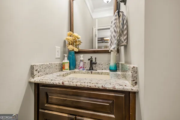 a living room with furniture and a view of kitchen