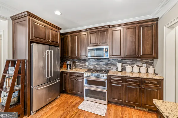 a dining room with furniture and wooden floor