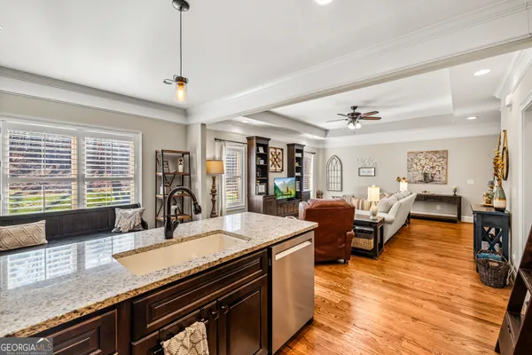 a living room with lots of furniture and a large window