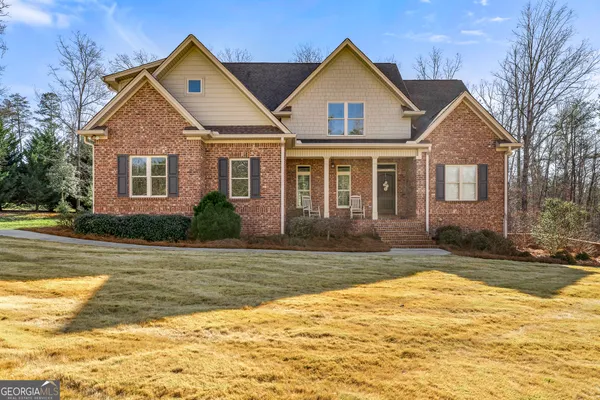 a front view of a house with a yard
