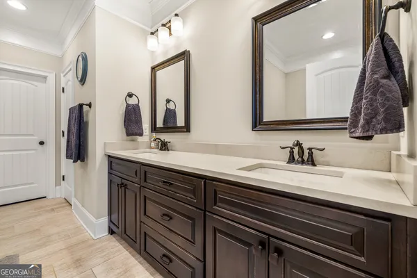 a bedroom with a bed dresser and a large mirror
