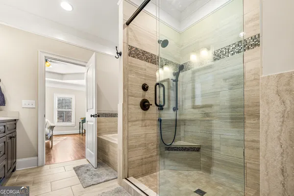 a bathroom with a bathtub and a shower