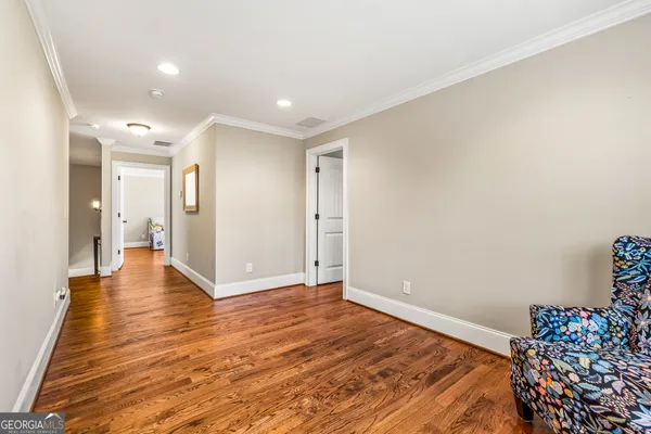 a view of a livingroom with wooden floor and a ceiling fan