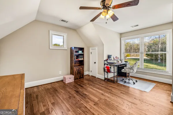 a bathroom with a granite countertop sink toilet a large mirror a bathtub and shower