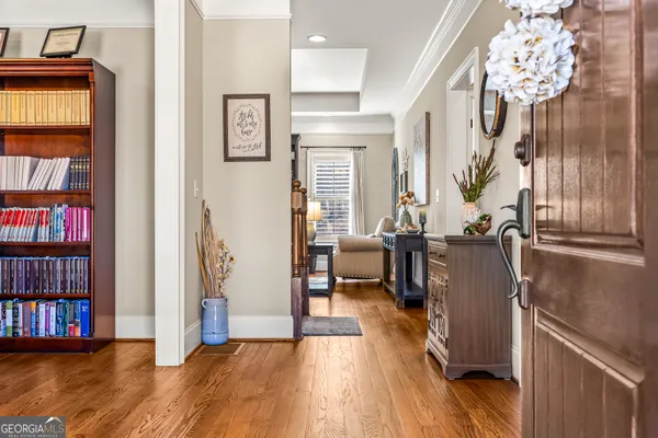 a view of a living room with furniture and wooden floor