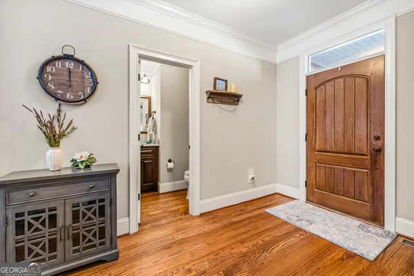 a room with wooden floor and furniture