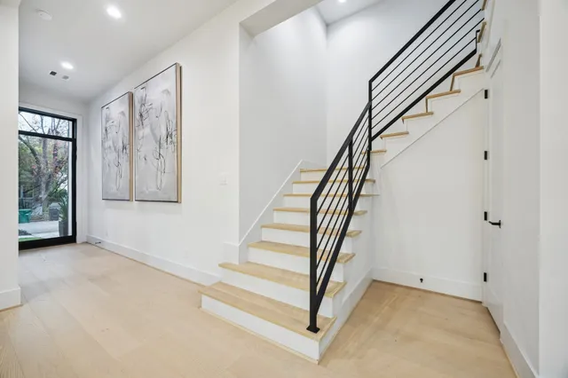 a view of a workspace with furniture and wooden floor