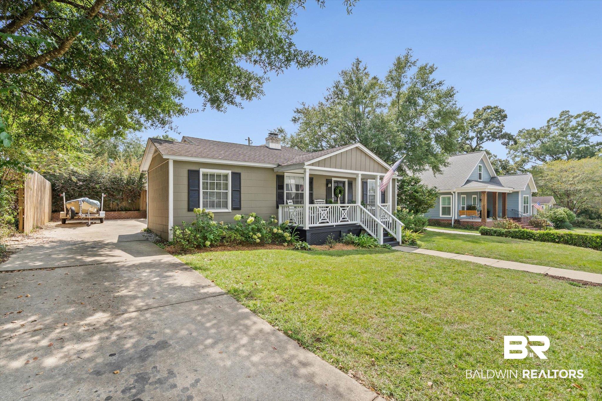 77 North Hathaway Road Mobile, AL 36608 - Photo 29 of 33 Bungalow-style house with a porch, a chimney, concrete driveway, and roof with shingles