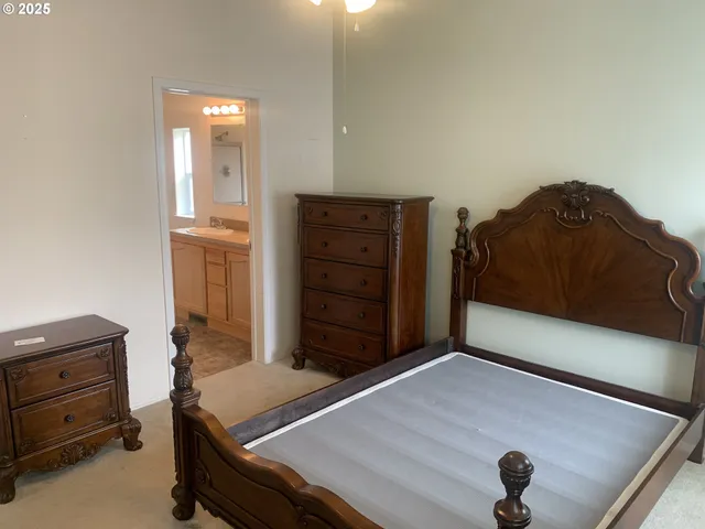 a bedroom with a bed and a dresser