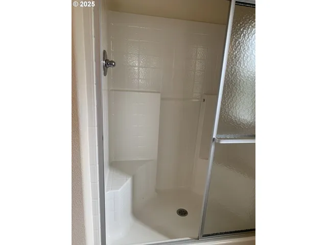 a bathroom with a glass shower door