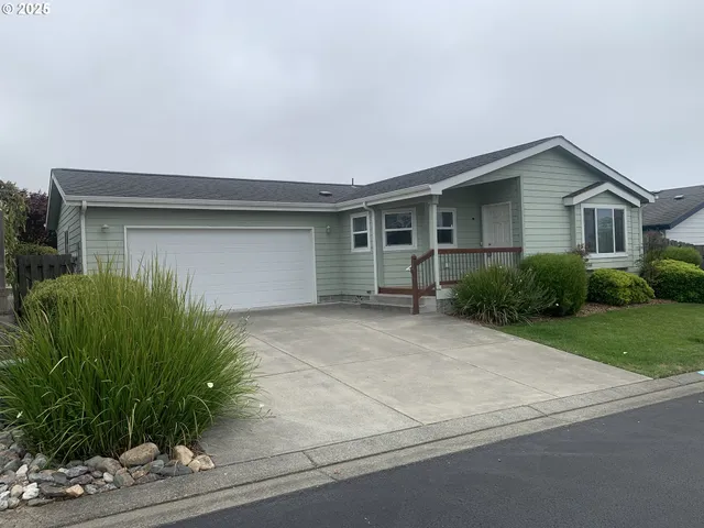 a front view of house with yard and trees around