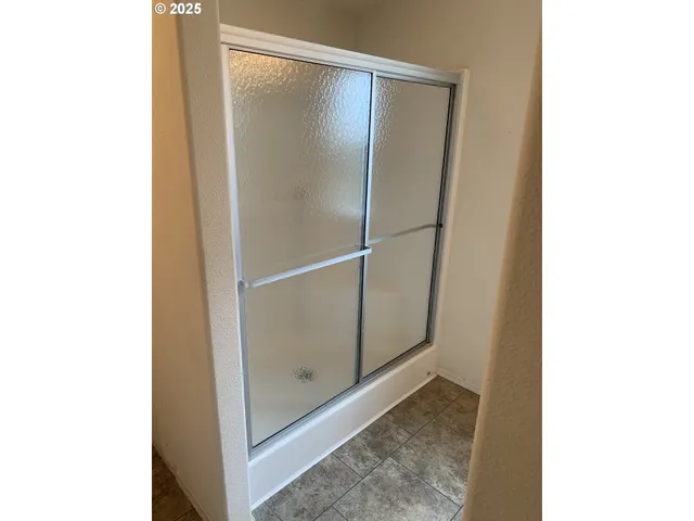 a bathroom with a glass shower door
