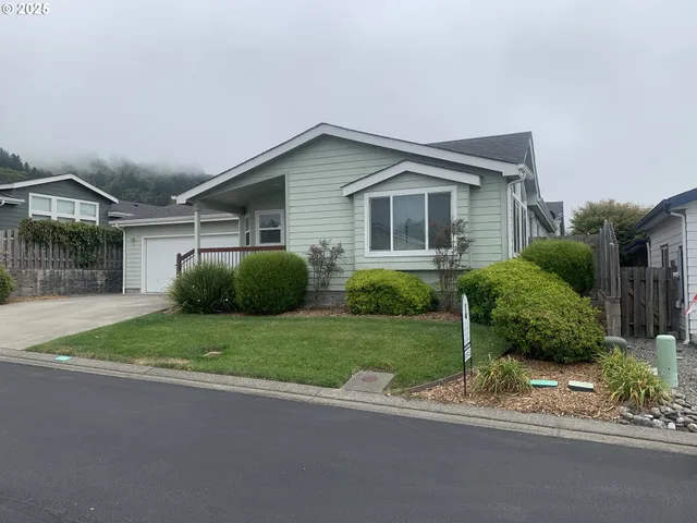 a front view of a house with a yard and a garage