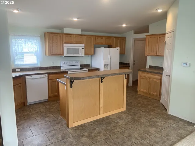 a kitchen with cabinets a sink and appliances