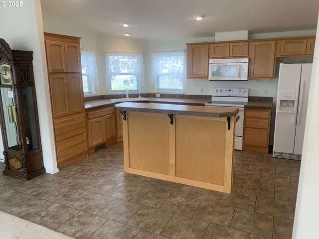 a kitchen with a refrigerator and a sink