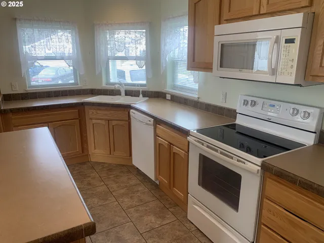 a kitchen with a stove microwave and sink